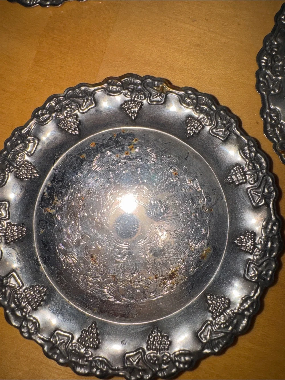six vintage silver-plated drink coasters with ornate, embossed floral